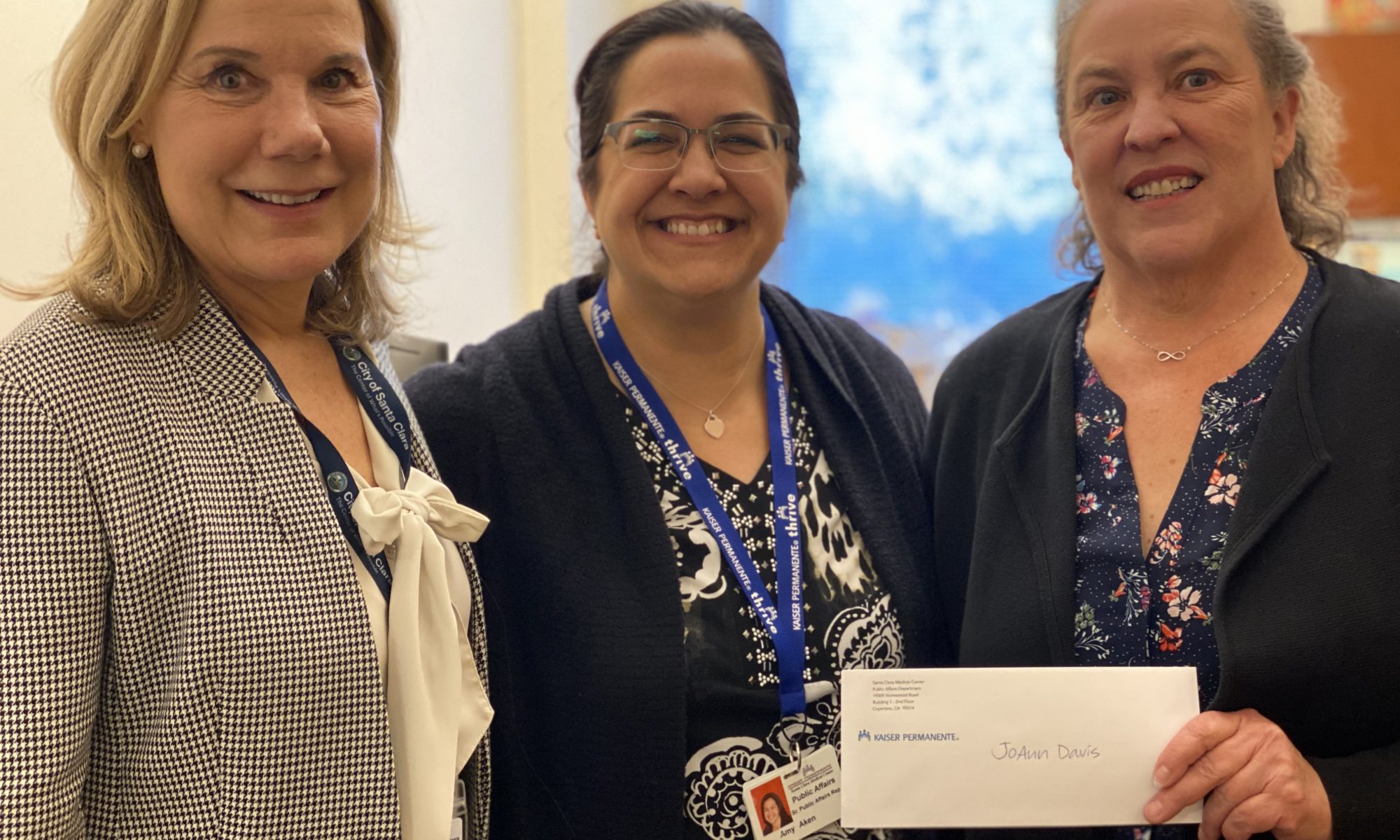 Amy Aken from Kaiser Permanente presenting their donation to Hilary Keith, City Librarian and JoAnn Davis, Executive Director, to support Health and Wellness classes and events at the Santa Clara City Library