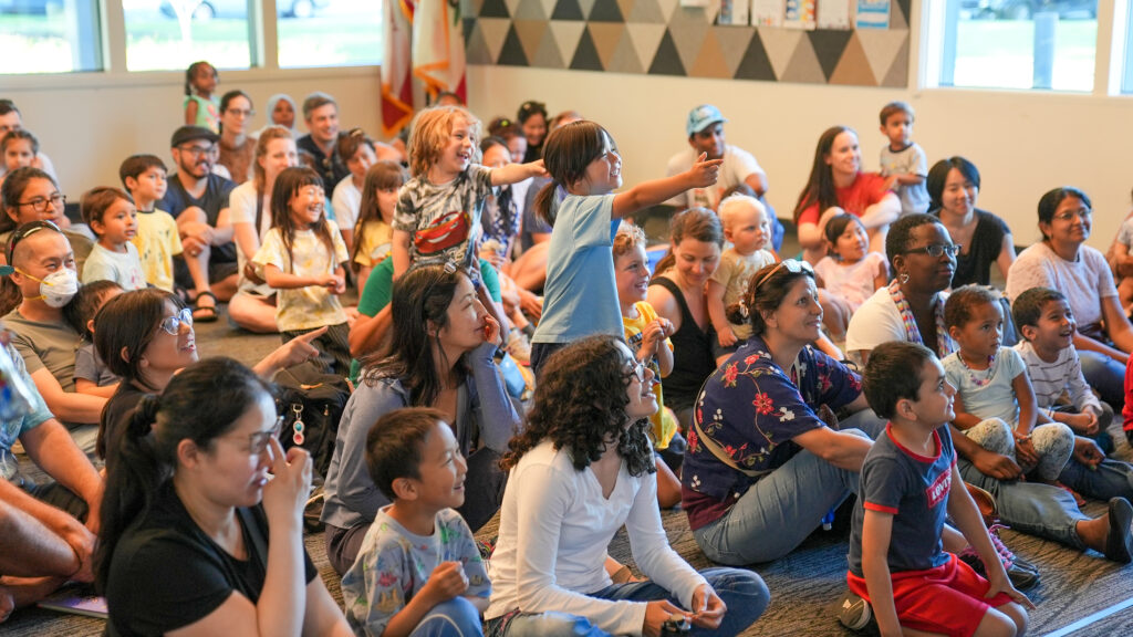 A group of happy families at a Coventry and Kaluza show at the Mission Branch Library. This show was part of the Summer Adventure series at The Santa Clara City Library.