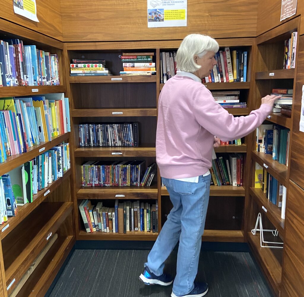 A customer shopping at the book nook at Northside Library, a branch of the Santa Clara City Library. Sales at The Nook support the Santa Clara City Library Foundation and Friends.